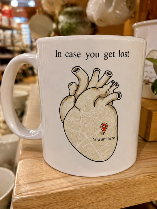 White ceramic heart map mug reading In case you get lost, You are here